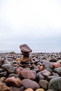 Rocks on beach against sky