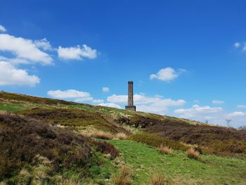 Built structure on field against sky