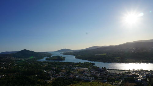 Scenic view of lake and mountains against clear sky