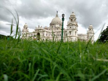 Low angle view of temple against cloudy sky