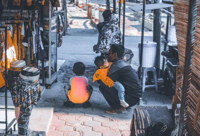 People sitting in shopping cart