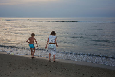 People on beach against sky