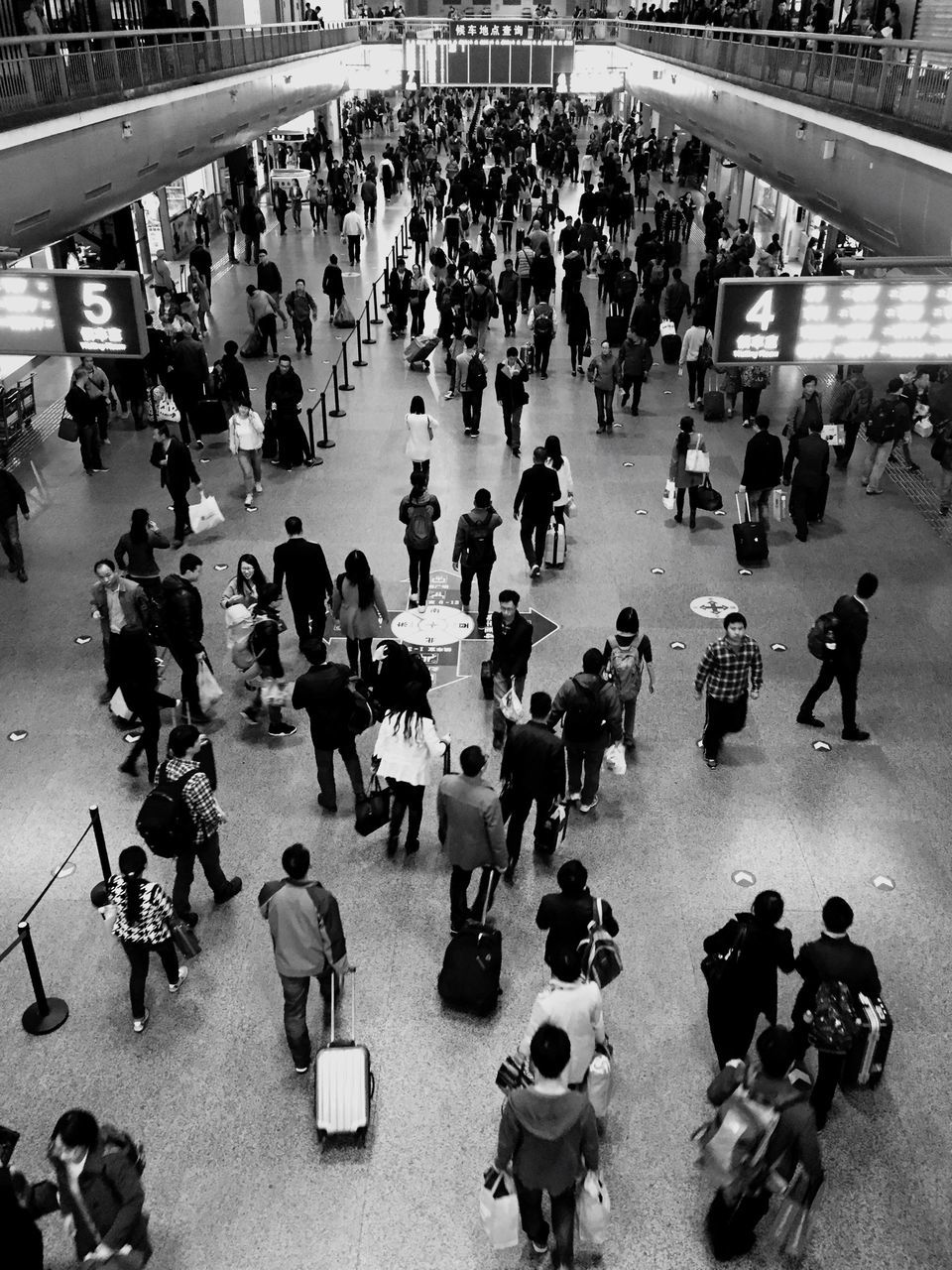 large group of people, person, men, crowd, high angle view, lifestyles, mixed age range, street, city life, walking, leisure activity, indoors, transportation, travel, standing, day, city, crowded, road