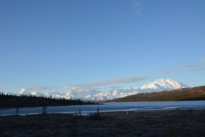 Scenic view of snowcapped mountains against sky during winter