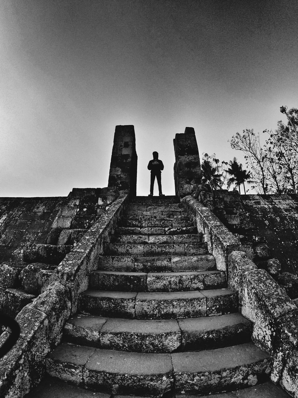 full length, steps, the way forward, rear view, lifestyles, steps and staircases, walking, men, leisure activity, standing, staircase, silhouette, low angle view, person, clear sky, built structure, architecture, stairs