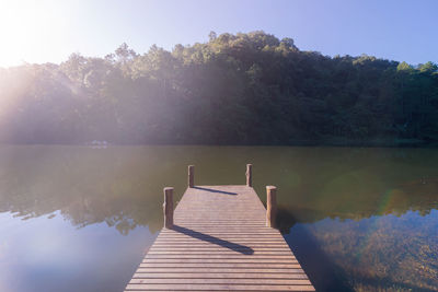 Pier on lake against sky
