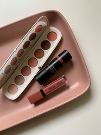 Close-up of make-up in tray on table