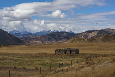 Scenic view of field and mountains against sky