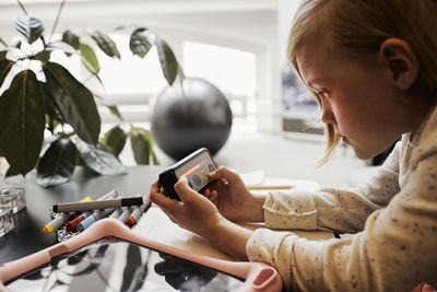 Girl at occupational therapy session using electronic game