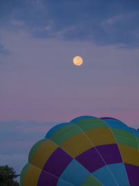 Low angle view of hot air balloon against sky at sunset