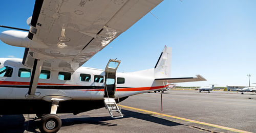 Airplane on airport runway against clear sky