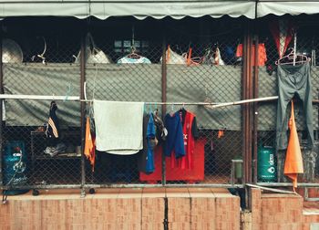 Clothes drying on chainlink fence in back yard