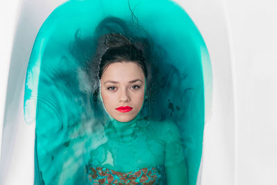 Directly above portrait of beautiful young woman in bathtub