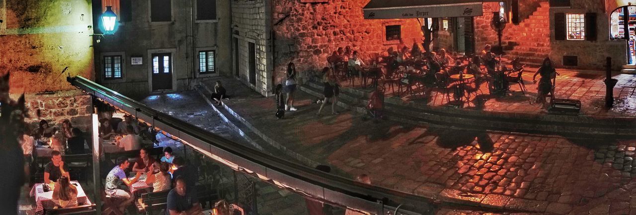 HIGH ANGLE VIEW OF PEOPLE AT ILLUMINATED STREET MARKET