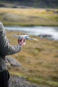 Cropped man takes off the drone in the air