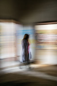 Rear view of woman walking in bus