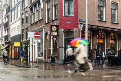 Blurred motion of people walking on street in city