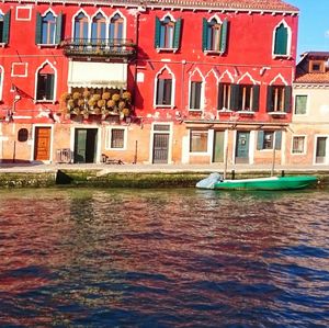 Canal by buildings in city