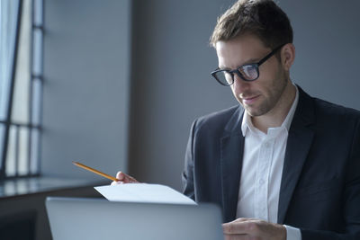 Young man using laptop at table