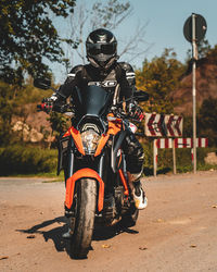 Man riding motorcycle on road