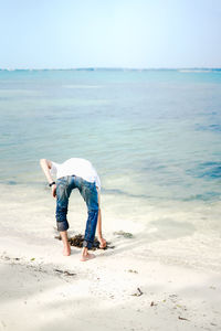 Full length of boy on beach against sky