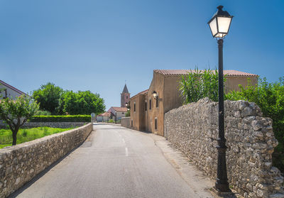 Street amidst buildings against sky