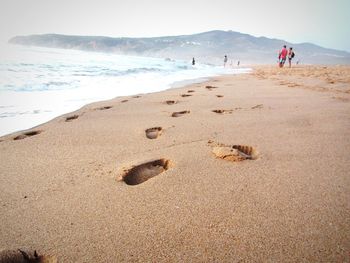 Footprints on sand at beach