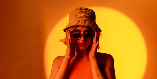 Portrait of young woman wearing hat