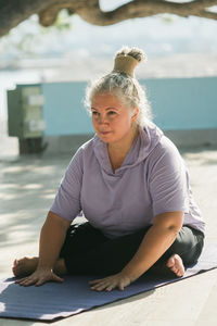 Portrait of young woman sitting on table