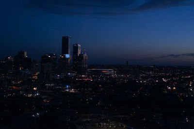 High angle view of illuminated buildings against sky at night