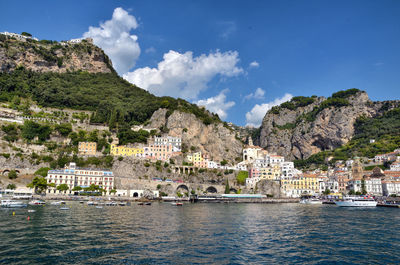 View of town by river with houses in background