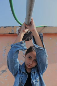 Portrait of girl holding metal