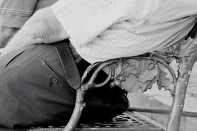 Midsection of man sitting on bench