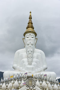 Statue of temple against building