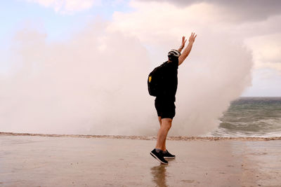 Full length of man standing on beach