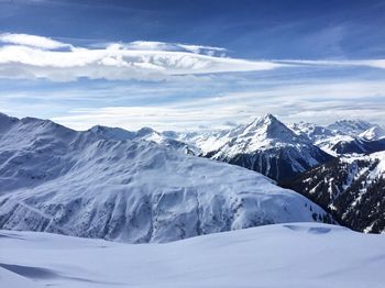 Scenic view of snow mountains against blue sky