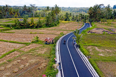 Road amidst field against sky