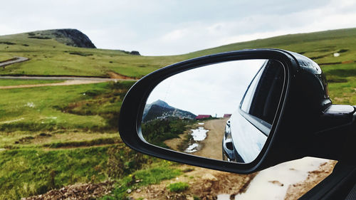 Reflection of road on side-view mirror