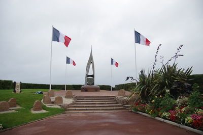 Flag against sky at cemetery