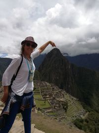 Optical illusion of woman touching huayna picchu at machu picchu