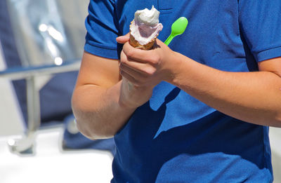 Midsection of man holding ice cream