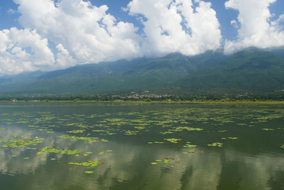 Scenic view of lake and mountains against sky