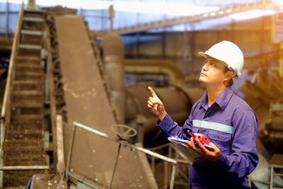 Engineer gesturing while standing in factory