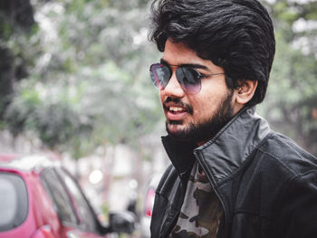 Portrait of young man wearing sunglasses outdoors