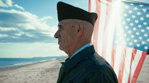 Side view of man standing at beach