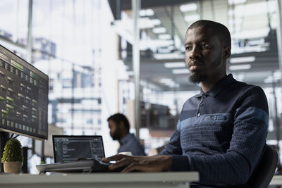 Young man using laptop at office