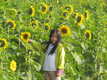 Portrait of smiling girl standing in field