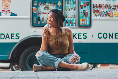 Full length of young woman looking away