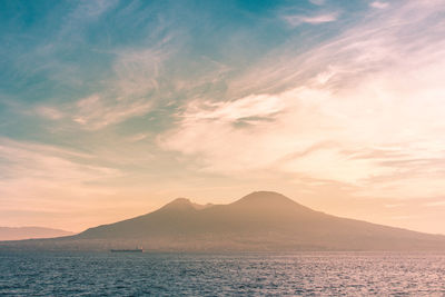 Scenic view of sea and volcano against sky