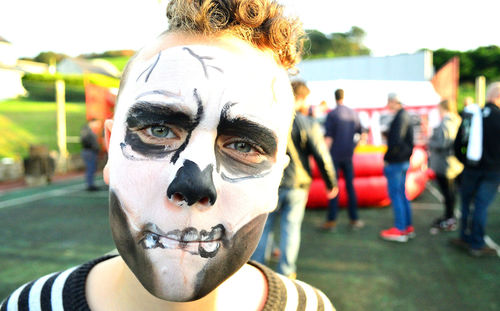 Close-up portrait of man with day of the dead face paint